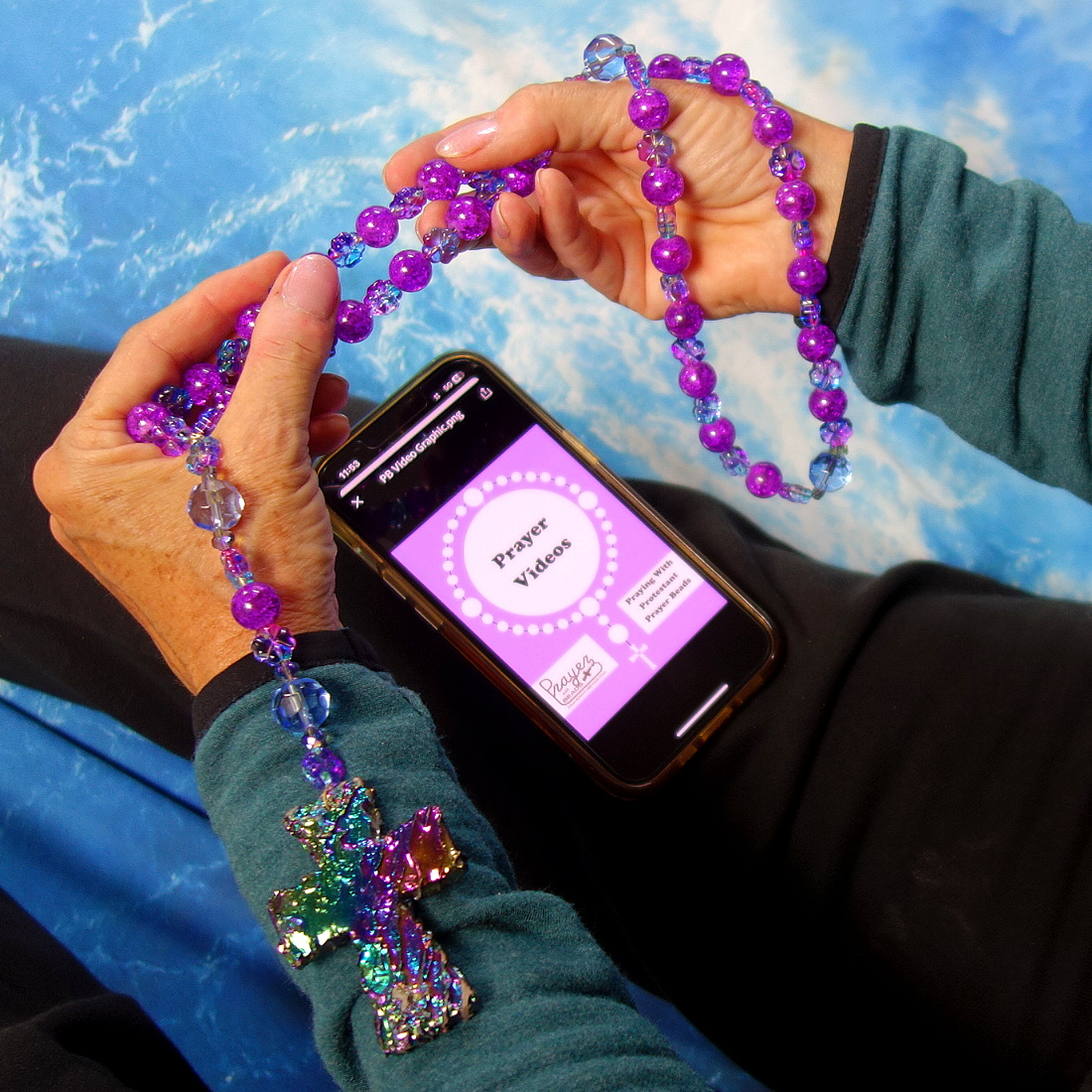 Watching guided prayer video while praying with prayer beads