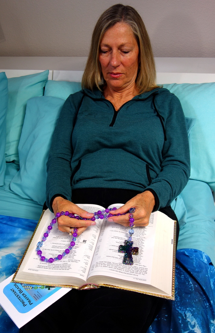 Woman using Protestant Ppayer beads