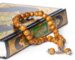 Tasbih Islamic prayer beads made of wood resting on a Quran