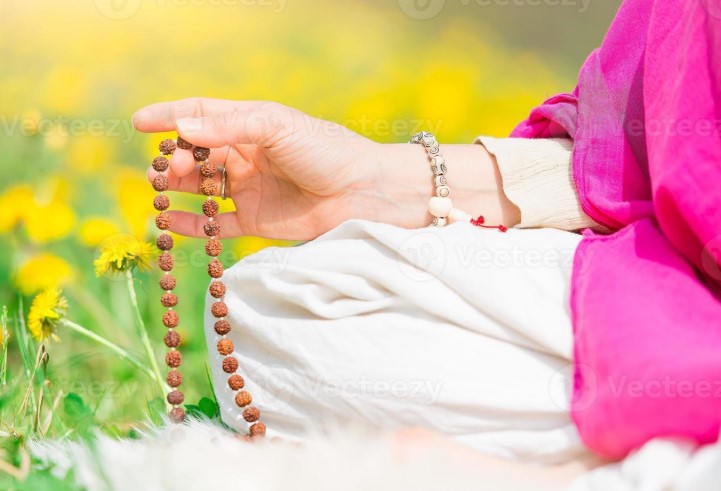 Woman meditating with rudraksha bead mala