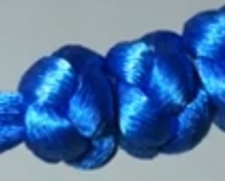 Close-up of Orthodox prayer rope knot showing cross pattern formed within the knot
