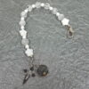 White Protestant chaplet bracelet with white shell flower beads, crackle glass, rhinestone cross, and loved heart pendant