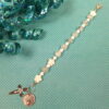 White Protestant chaplet bracelet with white shell flower beads, crackle glass, rhinestone cross, and loved heart pendant