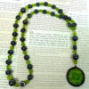 Green Leaves Hematite prayer bead necklace with hematite roller beads, green glass leaf spacers, and floral pendant
