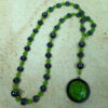 Green Leaves Hematite prayer bead necklace with hematite roller beads, green glass leaf spacers, and floral pendant