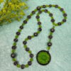 Green Leaves Hematite prayer bead necklace with hematite roller beads, green glass leaf spacers, and floral pendant