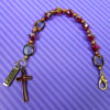Faceted Burgundy Protestant chaplet bracelet with burgundy glass beads, coppertone accents, cross pendant, and It Is Well With My Soul pendant