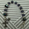 Rainbow Crosses Protestant chaplet bracelet with iridescent glass beads, silver-plated cross beads, and Believe pendant