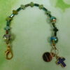 Rainbow Crosses Protestant chaplet bracelet with iridescent glass beads, silver-plated cross beads, and Believe pendant