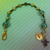 Rainbow Crosses Protestant chaplet bracelet with iridescent glass beads, silver-plated cross beads, and Believe pendant