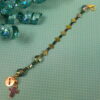 Rainbow Crosses Protestant chaplet bracelet with iridescent glass beads, silver-plated cross beads, and Believe pendant